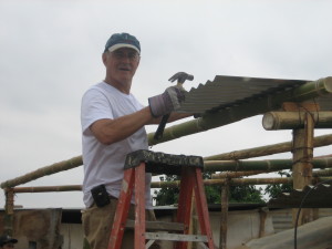 Putting on a tin roof for a new house in Piura, Peru.